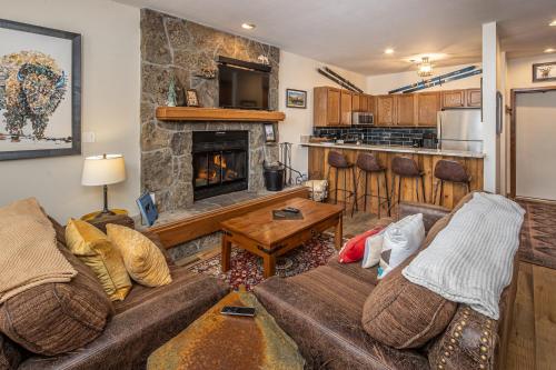 a living room with two couches and a fireplace at Snowflake at Skycrest in Big Sky
