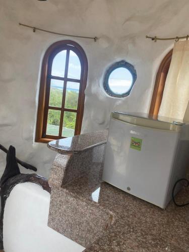 a room with a table and a tv on the floor at La Fortaleza De Haro in Puerto Ayora