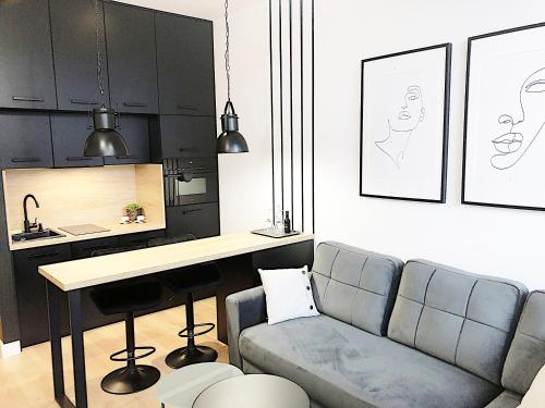 a living room with a couch and a table at Apartimento Hydral Fiori in Wrocław