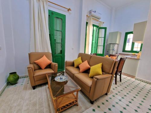 a living room with two couches and a table at AMY Brothers Apartments in Tangier
