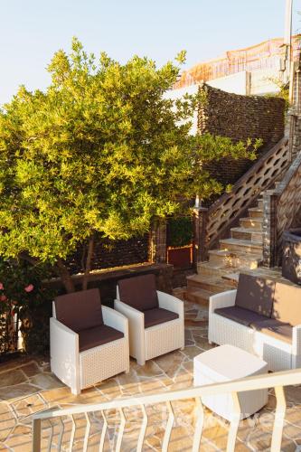 a patio with two chairs and a table and stairs at La casa di Luisa in Moneglia