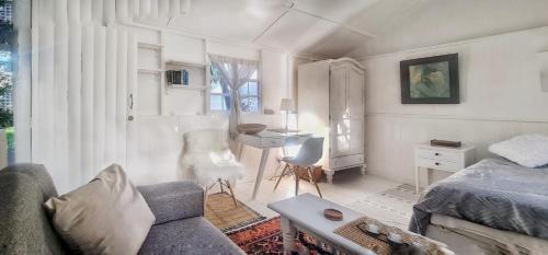 a living room with a couch and a desk at Oh so Heavenly in Cape Town