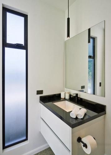 a bathroom with a sink and a mirror at Ocean view Villa Alba 4ensuite rooms Malpais Santa Teresa in Mal País