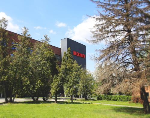 a sign for a building with trees in front of it at Apartimento Hydral Fiori in Wrocław