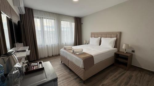 a hotel room with a bed and a television at Мотел Ханай 