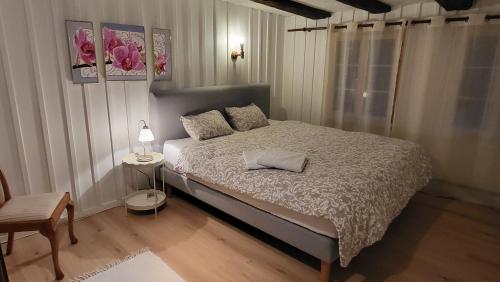 a bedroom with a bed and a table with a lamp at Room in cosy traditional swiss house 