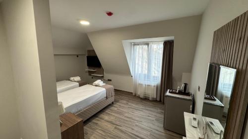 a hotel room with a bed and a window at Мотел Ханай 