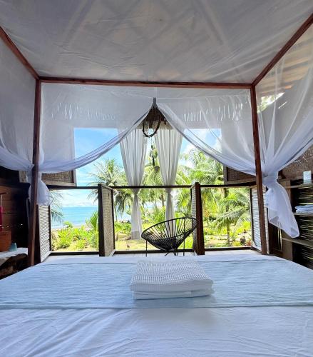 a bedroom with a bed with a view of the ocean at Ecohotel Luzul in Nuquí
