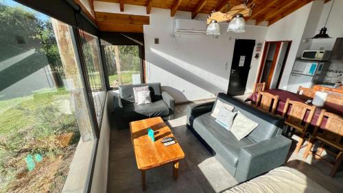 a living room with a couch and chairs and a table at Fincas del Faldeo in Villa General Belgrano
