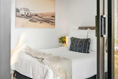 a bedroom with a bed with a picture on the wall at Civic - Civic Central in Newcastle