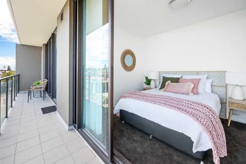 a bedroom with a bed and a balcony at 901 - Perfect Penthouse - With Free Parking in Newcastle