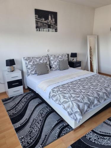 a large white bed in a room with a rug at Ferienwohnung Sabina in Bosanska Krupa