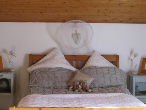 a bedroom with a bed with a clock on the wall at Romantic Cottage Retreat for Two in South Vienne in Champniers