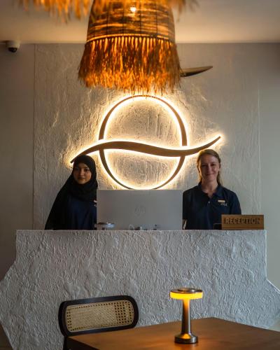 a man and a woman standing in front of a mirror at Oya Maldives Himmafushi in Himmafushi