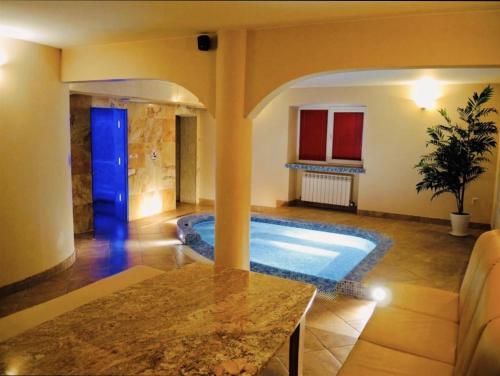 a living room with a pool in a house at White Home & Garden in Klaipėda