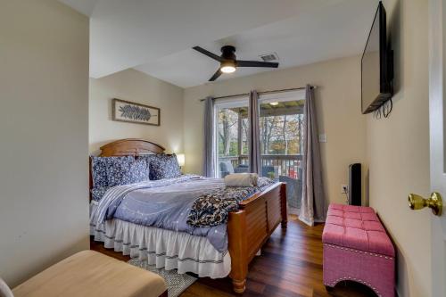 a bedroom with a bed and a window at Lakefront Pocono Retreat with Hot Tub and Movie Hub in Pocono Summit Estates