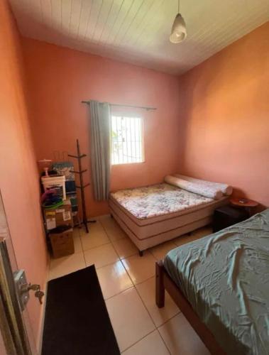 a bedroom with a bed and a window at Casa Aconchegante COP 30 in Ananindeua