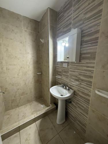 a bathroom with a sink and a mirror at Continente Park in San Clemente del Tuyú