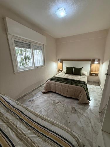 a bedroom with a bed and a window at Continente Park in San Clemente del Tuyú