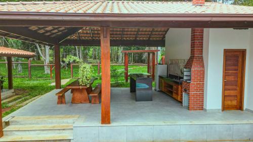 un patio con un padiglione con tavolo e panche di Canto dos Pássaros a Itacaré