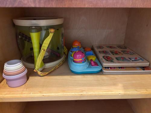 a shelf with a coffee pot and toys on it at Paradise Surf House in Galveston
