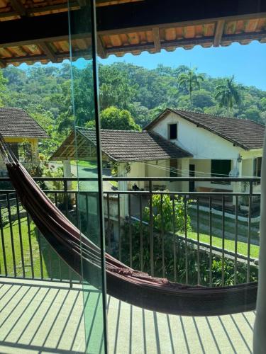a hammock on the balcony of a house at Recanto do Bosque in Majé