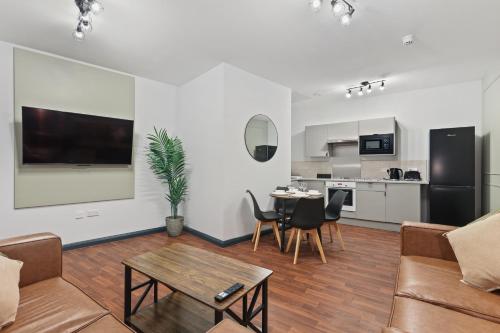 a living room with a couch and a table at Clayton Apartments in Newcastle upon Tyne