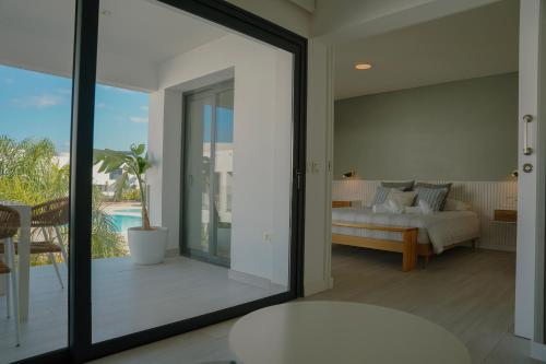 a bedroom with a bed and a sliding glass door at Sunset House Fuerteventura in Villaverde