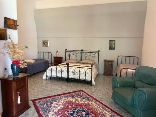 a living room with two beds and a couch at Oasi Rupestre in Montescaglioso