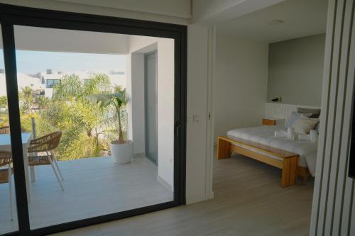 a bedroom with a view of a bed and a balcony at Sunset House Fuerteventura in Villaverde