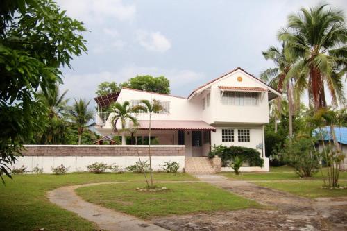 een wit huis met palmbomen en een oprit bij Casa Kitesurf - 1 Min a Playa, Pool, BBQ in Chame