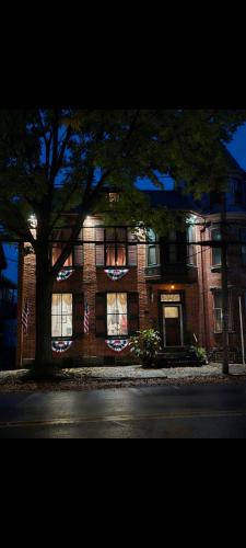 a brick building with a tree in front of it at Langdon Hill House Felty Room in Gettysburg