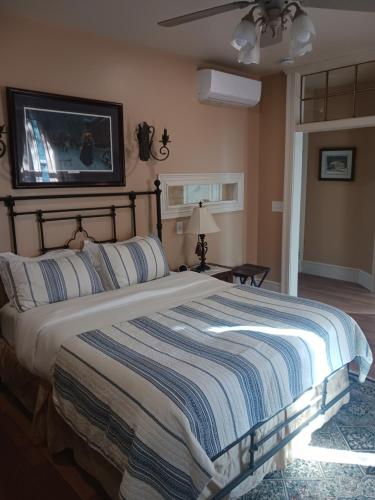 a bedroom with a large bed with a tv on the wall at Langdon Hill House Felty Room in Gettysburg