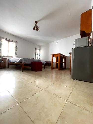 an empty living room with a couch and a table at TIlcara Rooms in Tilcara