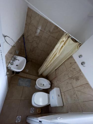 a small bathroom with two sinks and a toilet at TIlcara Rooms in Tilcara