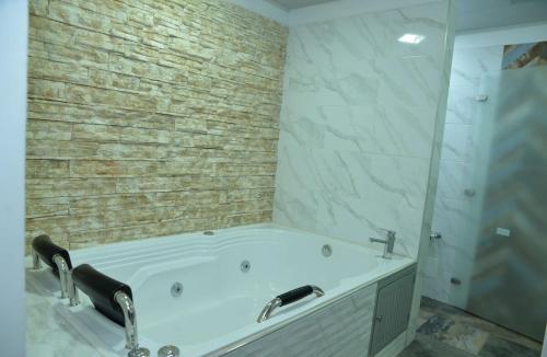 Casa jardin completa con parqueadero privado في إباغويه: حمام مع حوض استحمام به صنفين