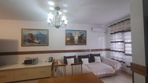 a living room with a bed and a dining table at Golem Green Retreat in Golem