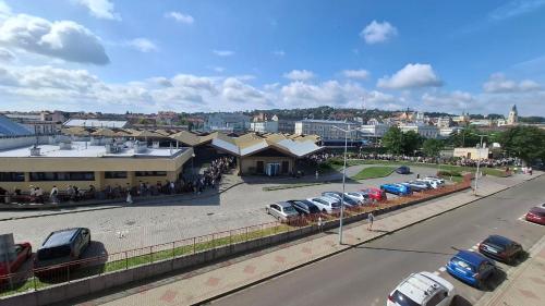 a parking lot with cars parked in front of a building at Serce Przemyśla Classic in Przemyśl
