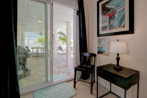 une pièce avec un bureau, une chaise et une porte coulissante en verre dans l'établissement The Golf Cart to Beach Hideaway!, à Clearwater Beach