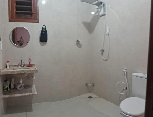 a bathroom with a shower and a toilet and a sink at Casa Canoa Aracati in Aracati