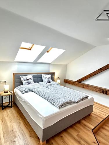 a bedroom with a bed and a skylight at Jagagütl in Saalfelden am Steinernen Meer