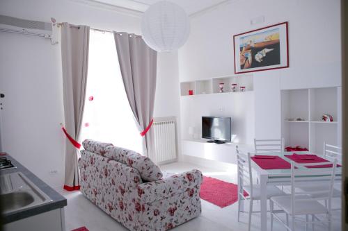 a living room with a chair and a table at San Giorgio by PizzoApartments in Pizzo