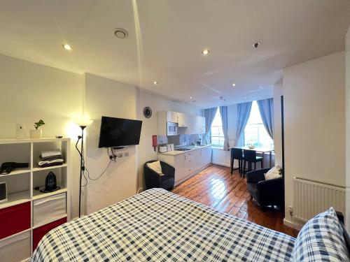 a bedroom with a bed and a living room at Quiet & Modern Studio in the Heart of Nottingham City Centre in Nottingham