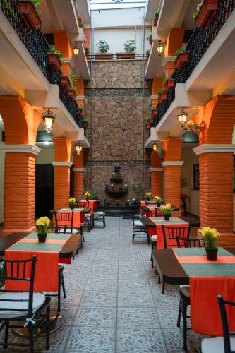 a restaurant with tables and chairs and a christmas tree at Hotel del Carmen, en el Centro- DESAYUNO Incluido ! in Tuxtla Gutiérrez