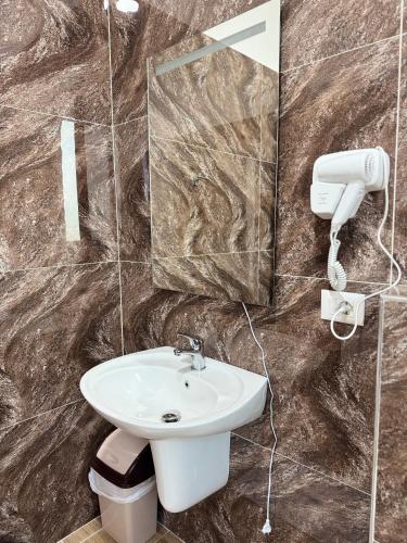 a bathroom with a sink and a mirror at Aerostay hotel 1 km from airport in Rinas