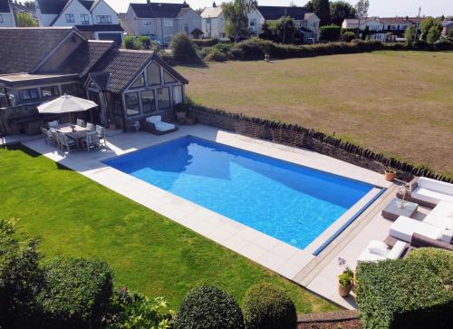 a swimming pool in the yard of a house at Harcombe Barn near Bristol in Bristol
