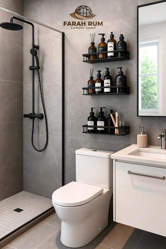 a bathroom with a shower and a toilet and a sink at FARAH RUM lUXURY CAMP in Wadi Rum