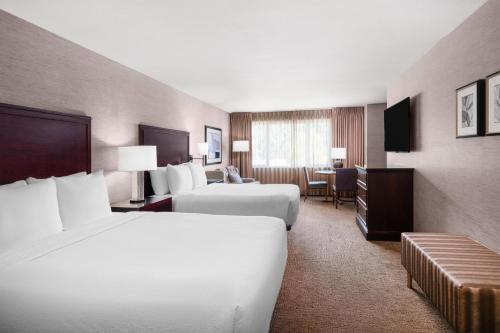 a hotel room with two beds and a desk at Eastgate Hotel - BW Signature Collection in Bellevue