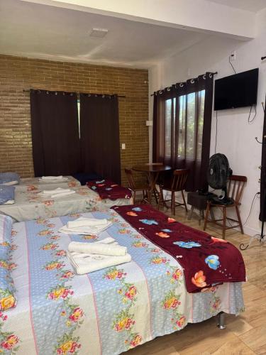 a bedroom with two beds with towels on them at Recanto do Bosque in Majé