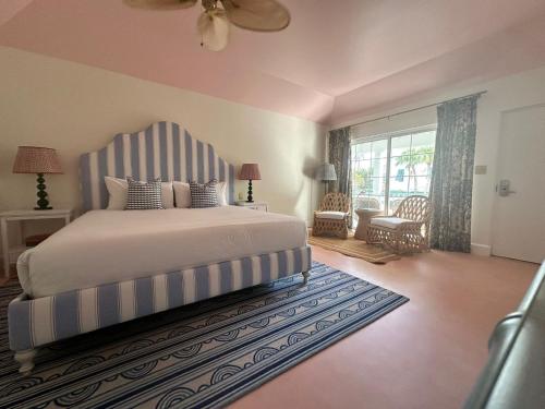 a bedroom with a bed with a blue and white striped headboard at Rosedon - Adults Only in Hamilton